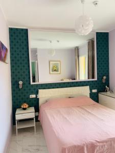 a bedroom with a pink bed and a mirror at Orlando Apartment in Adeje +53 photos
