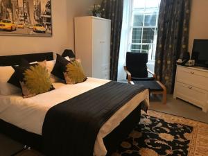 a bedroom with a bed and a chair and a window at 22 Chester Street in Edinburgh