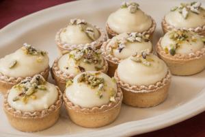 a plate of cupcakes with frosting and sprinkles at Hotel Montreal in Ragusa