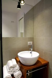 a bathroom with a sink and a mirror and towels at Why Not Roma Suite in Rome