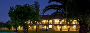 uma casa grande com luzes acesas à noite em La Perla Hotel em Santa Cruz