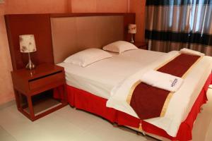 Postel nebo postele na pokoji v ubytování Horizon Hotel Apartments - الأفق للشقق الفندقية