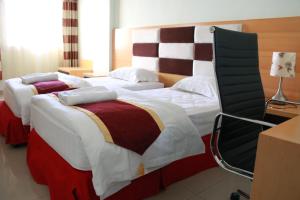 Postel nebo postele na pokoji v ubytování Horizon Hotel Apartments - الأفق للشقق الفندقية