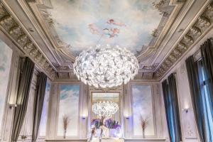a large chandelier in a room with a ceiling at Hotel C2 in Marseille