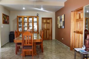 a dining room with a wooden table and chairs at Lucina's in San Ignacio