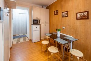 a kitchen with a table and chairs in a room at Alfa Apartments Svobody 31 in Lviv +14 photos