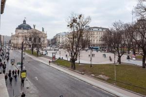 a city street with people walking on the sidewalk at Alfa Apartments Svobody 31 in Lviv