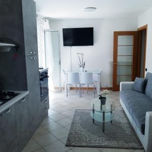 a living room with a couch and a table at RIVA DEL GARDA APART in Riva del Garda