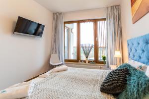 Łóżko lub łóżka w pokoju w obiekcie 3L Apartments Olympic Park