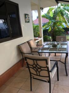 a dining table and chairs on a patio at Mountain View Villa in Sam Roi Yot