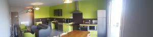 a kitchen with lime green walls and a couch at Ferme Ithurburia in Saint-Michel