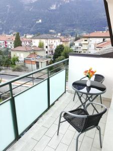a patio with a table and chairs on a balcony at Boschetto in Riva del Garda