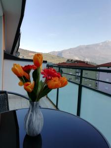 un vaso di fiori seduto su un tavolo con vista di Boschetto a Riva del Garda