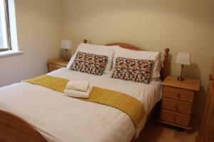 a bedroom with a large bed with two pillows at The Beach House in Enniscrone
