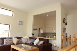 a living room with a couch and a table at The Beach House in Enniscrone