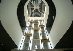 a staircase in a building with a large window at Le Magic Hôtel & Spa in Vitré