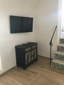 a living room with a television on a wall at Casa Cardi in Sperlonga