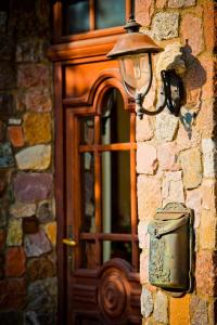 a light on the side of a building with a door at Villa Akacja in Łeba
