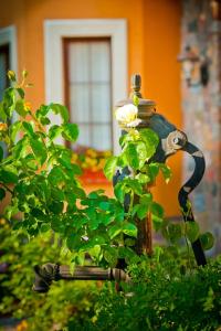a statue of a bird sitting on a fire hydrant at Villa Akacja in Łeba