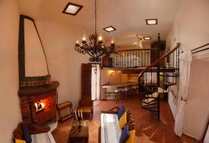 a living room with a staircase and a fireplace at Posada Los Alcatraces in Atlixco