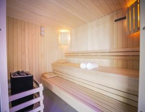 a room with a wooden floor and a large window at Le Magic Hôtel & Spa in Vitré