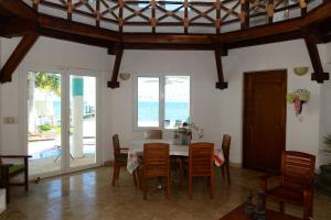 a dining room with a table and chairs and the ocean at Bella Casa Privada junto al Mar Caribe in Cancún