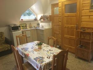 a kitchen with a table with a table cloth on it at Domek pod Maciejową in Rabka-Zdrój +21 photos