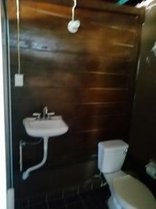 a bathroom with a sink and a toilet at Cabanas chaac Calakmul in Xpujil
