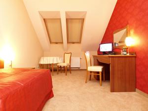 Posteľ alebo postele v izbe v ubytovaní Hotel Fajkier