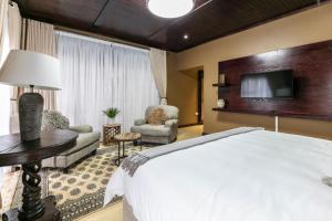 A bed or beds in a room at Orchid Luxury Boutique Guesthouse
