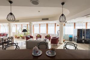 a living room with a couch and chairs and tables at Hotel La Baia in Bari
