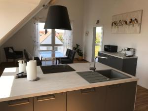 a kitchen with a sink and a counter top at Ferienwohnungen Scheuring 2.OG in Volkach