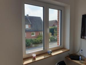 a window with a view of a house at Pension Pommernweg Ibbenbüren in Ibbenbüren