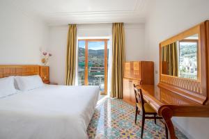 Кровать или кровати в номере Grand Hotel Flora