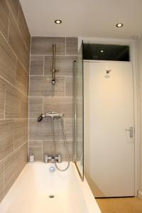 a shower with a glass door in a bathroom at Home and a Stay in Bristol