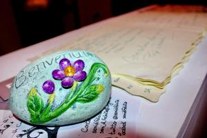 a rock with a flower painted on it sitting on a book at La Quiete in Rome