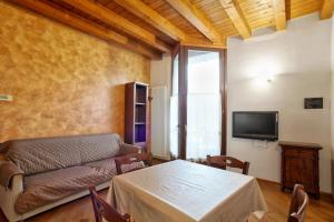 a living room with a couch and a table at COZY LAKE COMO APARTMENTS in Valmadrera