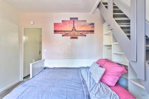 a bedroom with a bed and a staircase at Promotion du jour - Le Cerisier - in Deuil-la-Barre