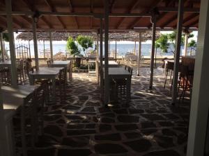 a row of tables and chairs on the beach at Kymata in Palaiopoli