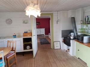 a kitchen with a table and a chandelier at MY LITTLE BED & BREAKFAST & HOLIDAY HOME in Älghult