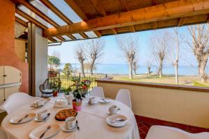 a table in a room with a view of the ocean at My Sirmione Beach Apartment Superior in Sirmione