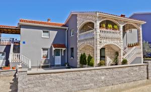 a large house with a stone retaining wall at Apartments LIMIA in Pula