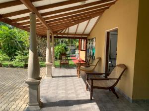 a patio with chairs and awning on a house at Bentota Villa in Bentota