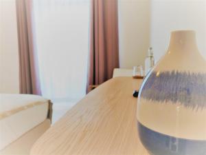 a vase sitting on top of a wooden table at Pure Fonte Velha B&B in Vila do Bispo
