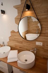 a bathroom with two sinks and a mirror at Very Berry - Podgorna 1c - Old City Apartments, check in 24h in Poznań