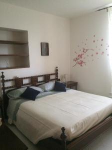 a bedroom with a large bed with red flowers on the wall at Casa Elena in La Spezia