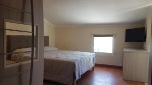 A bed or beds in a room at GARDAWORLD