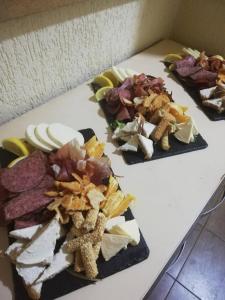 a table with three different types of food on it at Hotel Panorama city in Delčevo