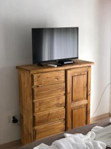 TV en la parte superior de una cómoda de madera en Family place en Luján