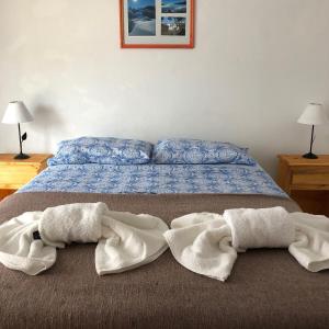 a bed with two towels on the floor next to it at Family place in Luján +70 photos